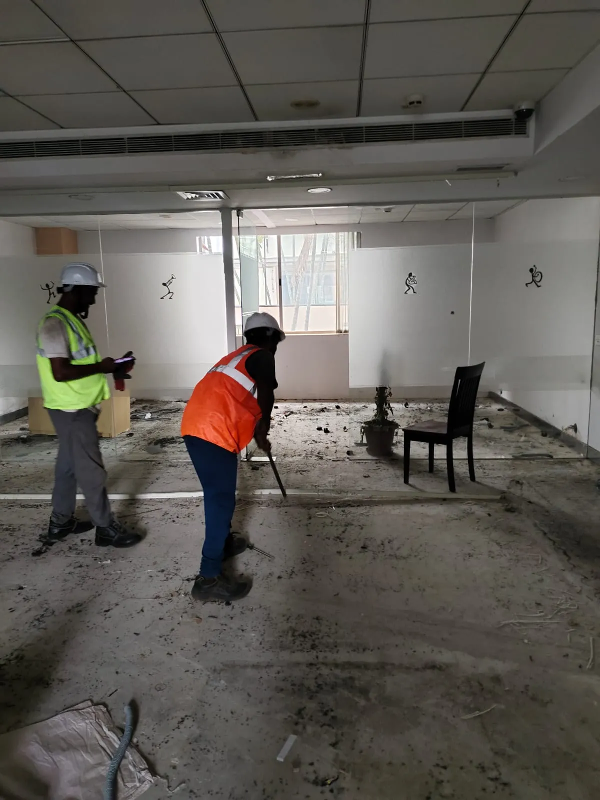 Gravity E-Waste Management crew clearing floors and dismantling partitions during a workstation removal and office exit clearance service in Whitefield, Bengaluru.